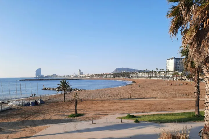 Barceloneta Beach and the sail-shaped silhouette of the W Hotel at the end of the sand