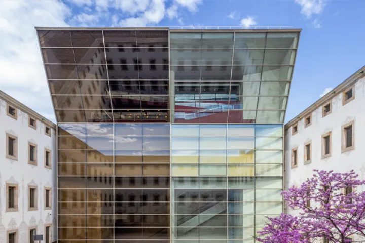 The slanted glass roof of the CCCB, reflecting the rooftops of Raval, between the walls of the former Casa de la Caritat