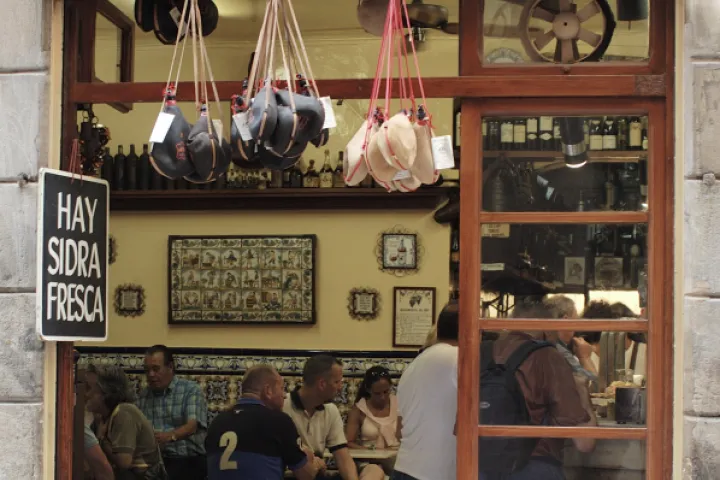 The façade and entrance of El Xampanyet bar, with its patrons.