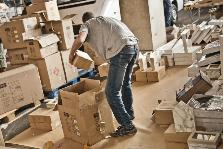 An employee at Mercat dels Encants preparing boxes and crates for auction