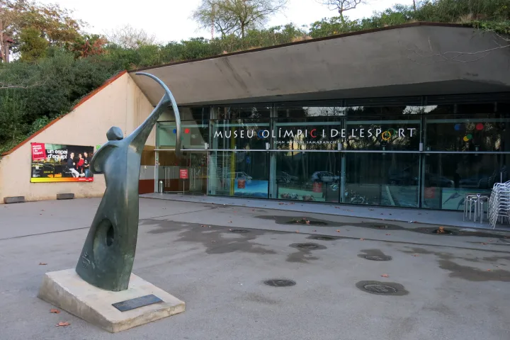 La entrada del Museo Olímpico y del Deporte, su letrero y la escultura del arquero de Rosa Serra