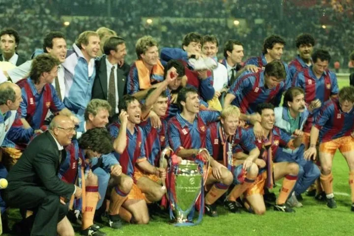 Die Spieler und das Management des FC Barcelona versammelten sich auf dem Rasen rund um den in Wembley 1992 gewonnenen Europapokal.