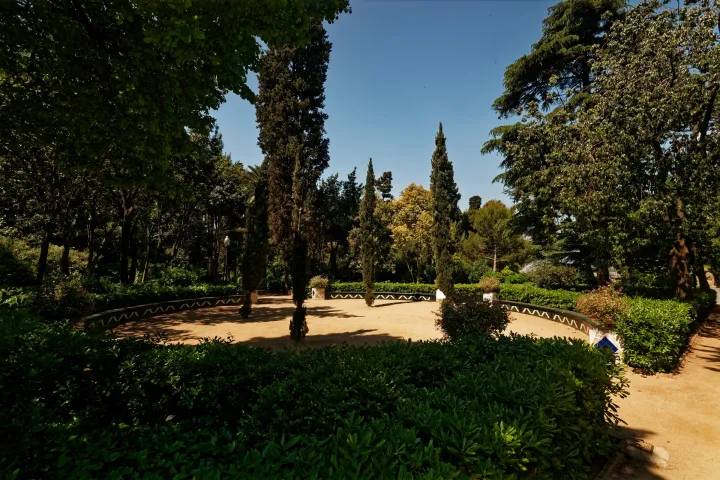 Um caminho nos Jardins de Laribal, entre sebes, pinheiros e terraços, na encosta de Montjuïc