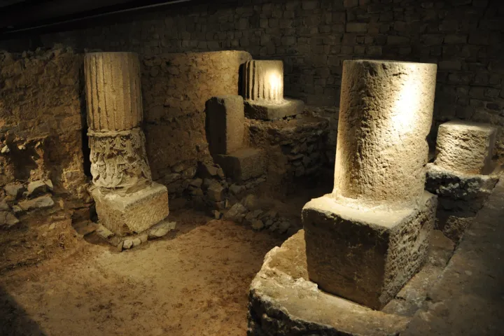Illuminated Roman column bases and walls in the archaeological subsoil of Barcino