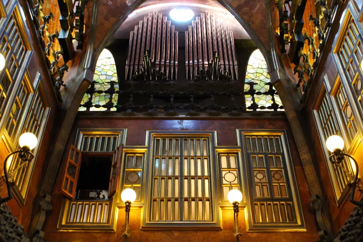 Die Orgelpfeifen des Palau Güell über den Buntglasfenstern, unter der Kuppel des zentralen Salons