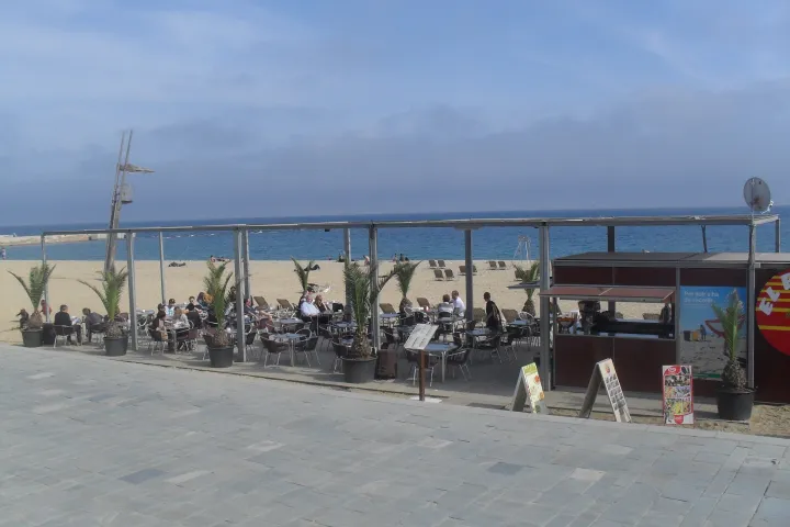 The terrace of a beach restaurant facing the sand and sea, near the Vila Olímpica