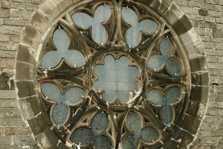 La pequeña roseta de Santa Maria del Mar vista de cerca desde la terraza, con su tracería de piedra y la mampostería alrededor