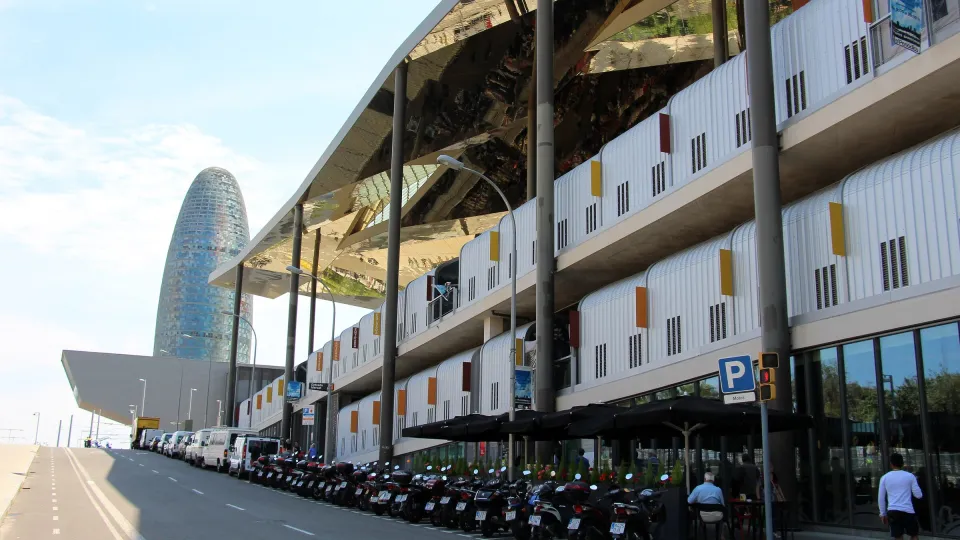 The golden canopy of the Mercat dels Encants along the avenue, with the Torre Glòries in the background