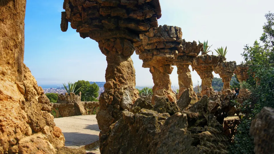 The stone viaduct of Park Güell and its leaning columns, a work by Antoni Gaudí