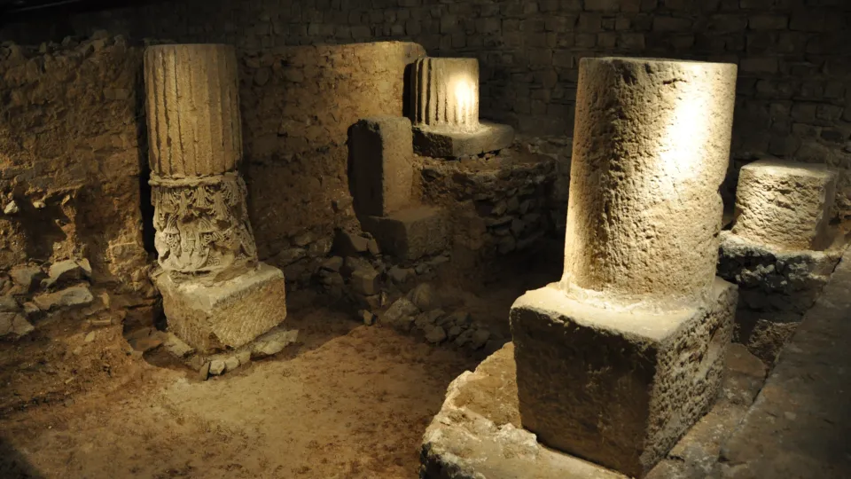 Bases of columns and Roman walls illuminated in the archaeological basement of Barcino